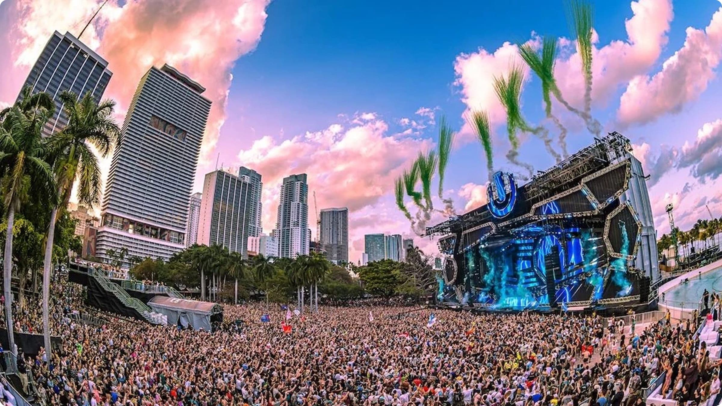 Crowd at Ultra Miami festival stage with lights and skyline in background
